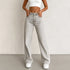 Wide leg jeans women with a low waist and distressed details, showcasing a stylish floor-length design in washed denim.