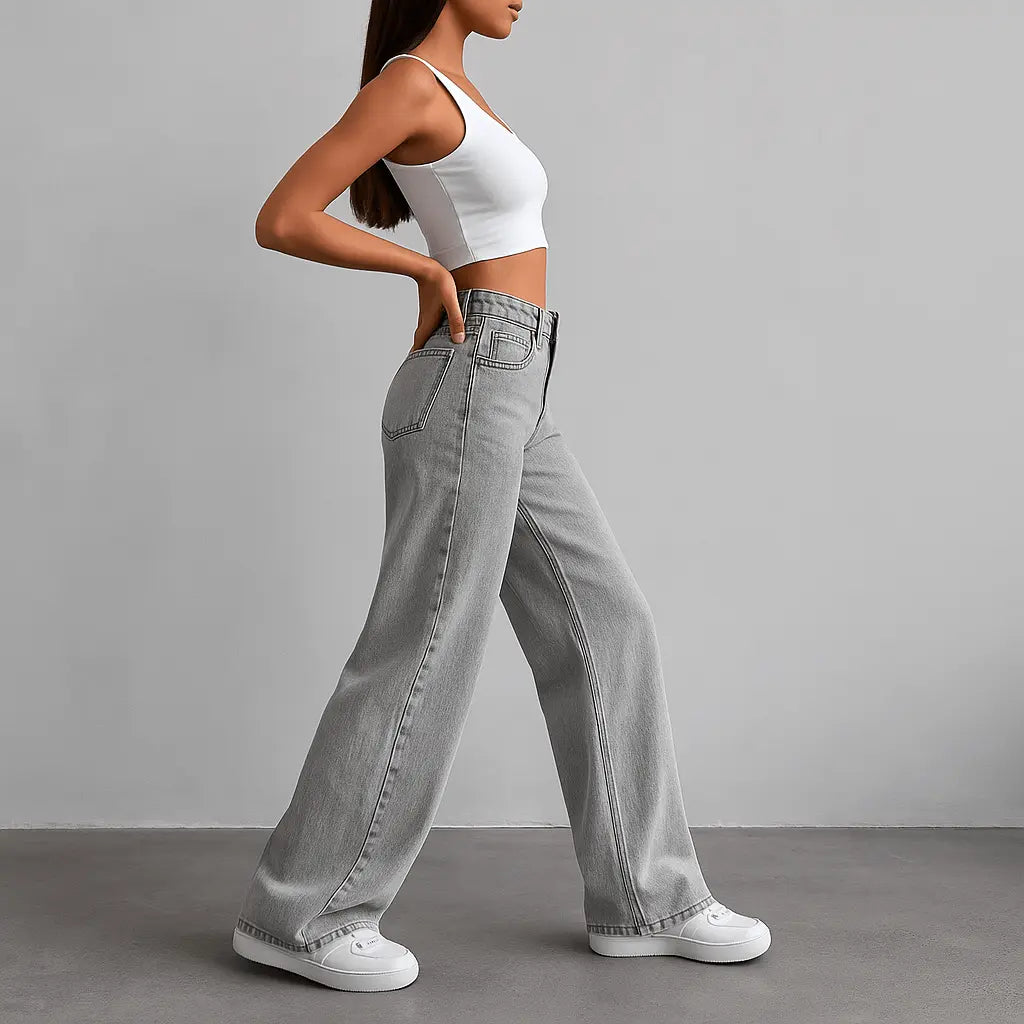 Stylish woman in wide leg jeans and crop top showcasing vintage streetwear aesthetic.